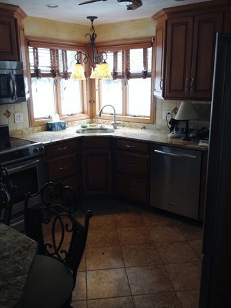 162 Beaconsfield Road Worcester, MA 01602 - Photo 4 of 7 a kitchen with granite countertop a sink stove and cabinets