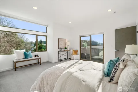 a bedroom with a bed mirror and lamp
