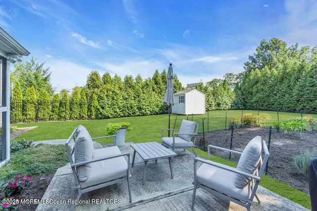 a view of a chair and table in the garden