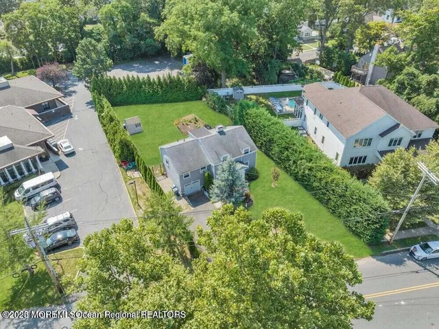 an aerial view of a house with garden space and street view