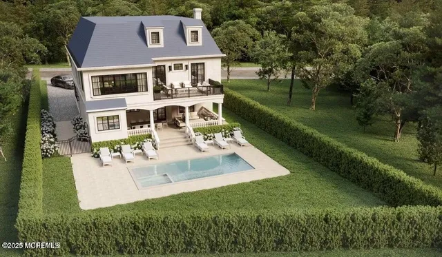 an aerial view of residential houses with outdoor space and trees