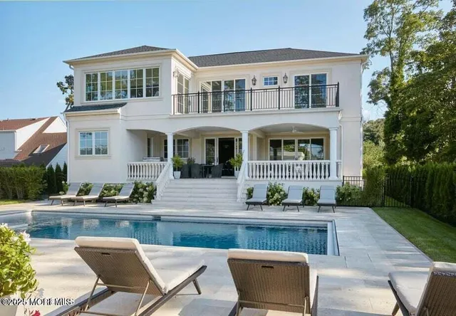 a view of house with yard and seating area