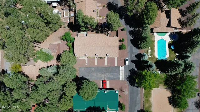 an aerial view of a house with a yard and trees