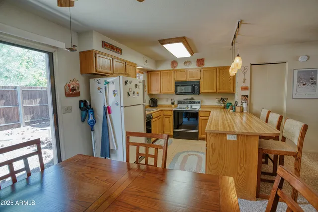 a kitchen with stainless steel appliances a refrigerator sink and microwave