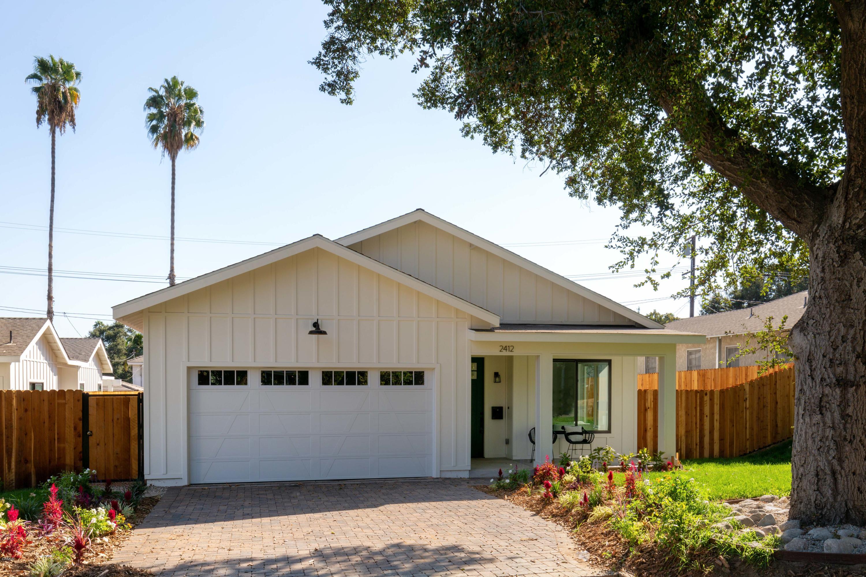 a front view of a house with a garden