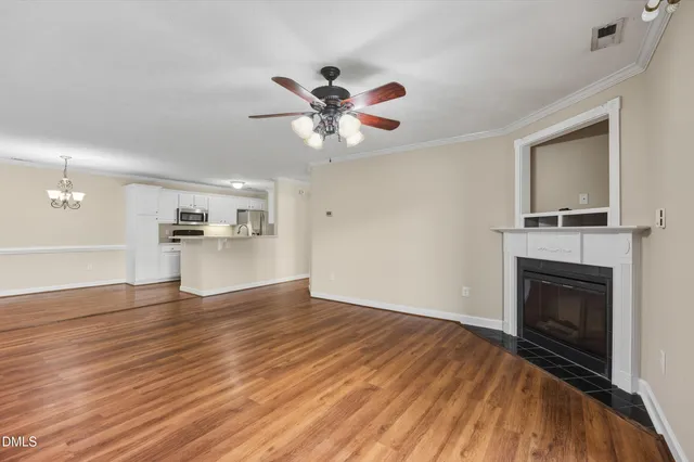 a view of a kitchen with wooden floor and a kitchen