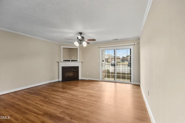 a view of a kitchen a ceiling fan wooden floor and a kitchen