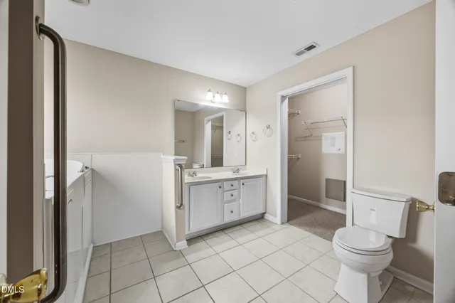 a spacious bathroom with a double vanity sink mirror and shower