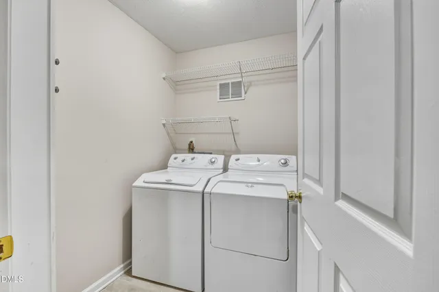 a bathroom with a double vanity sink toilet and a mirror