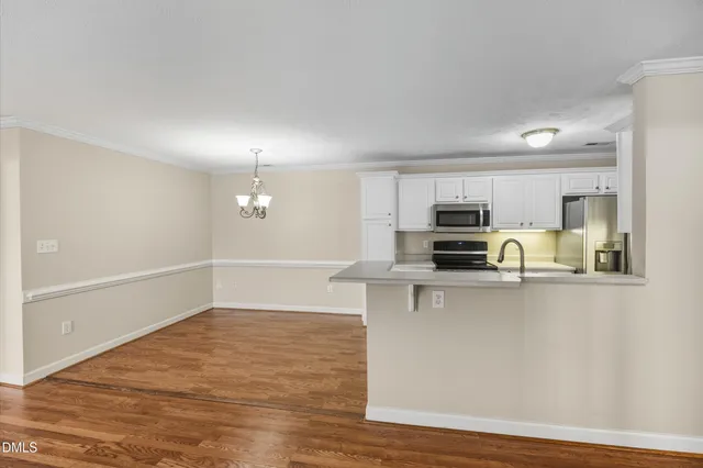 a kitchen with stainless steel appliances a stove refrigerator and cabinets