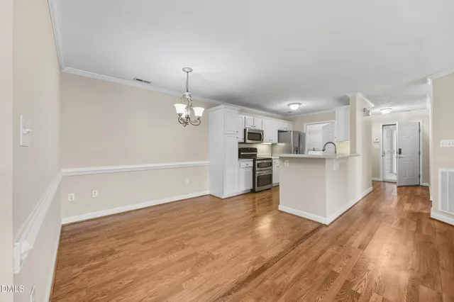 a kitchen with cabinets and a stainless steel refrigerator stove