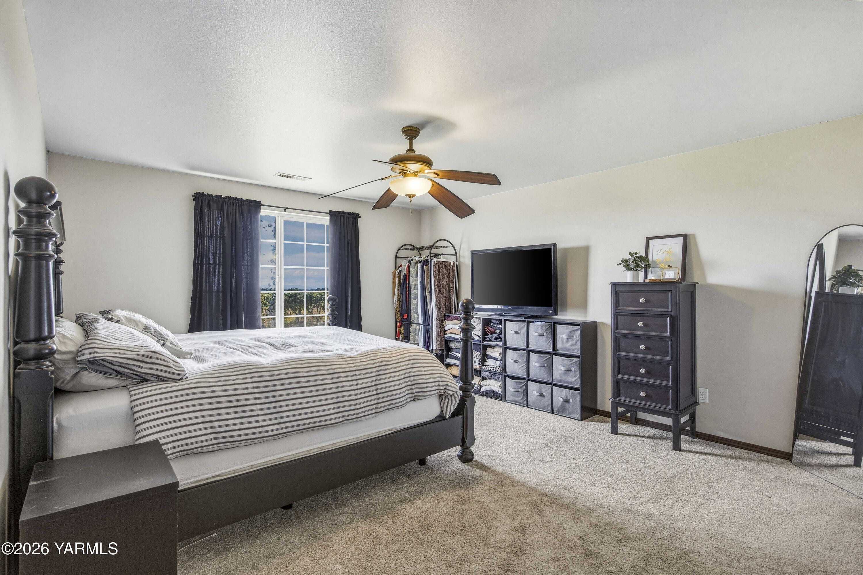2050 Olmstead Road Grandview, WA 98930 - Photo 14 of 60 a bedroom with a bed and a flat screen tv