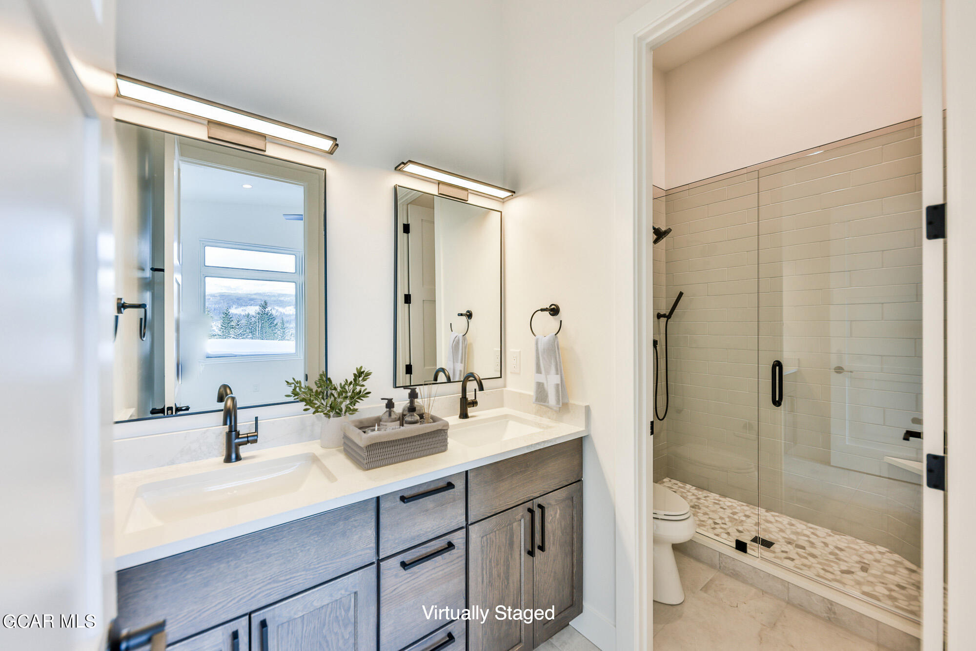 381 Bear Trail Winter Park, CO 80482 - Photo 15 of 38 a bathroom with a sink double vanity and a bathtub