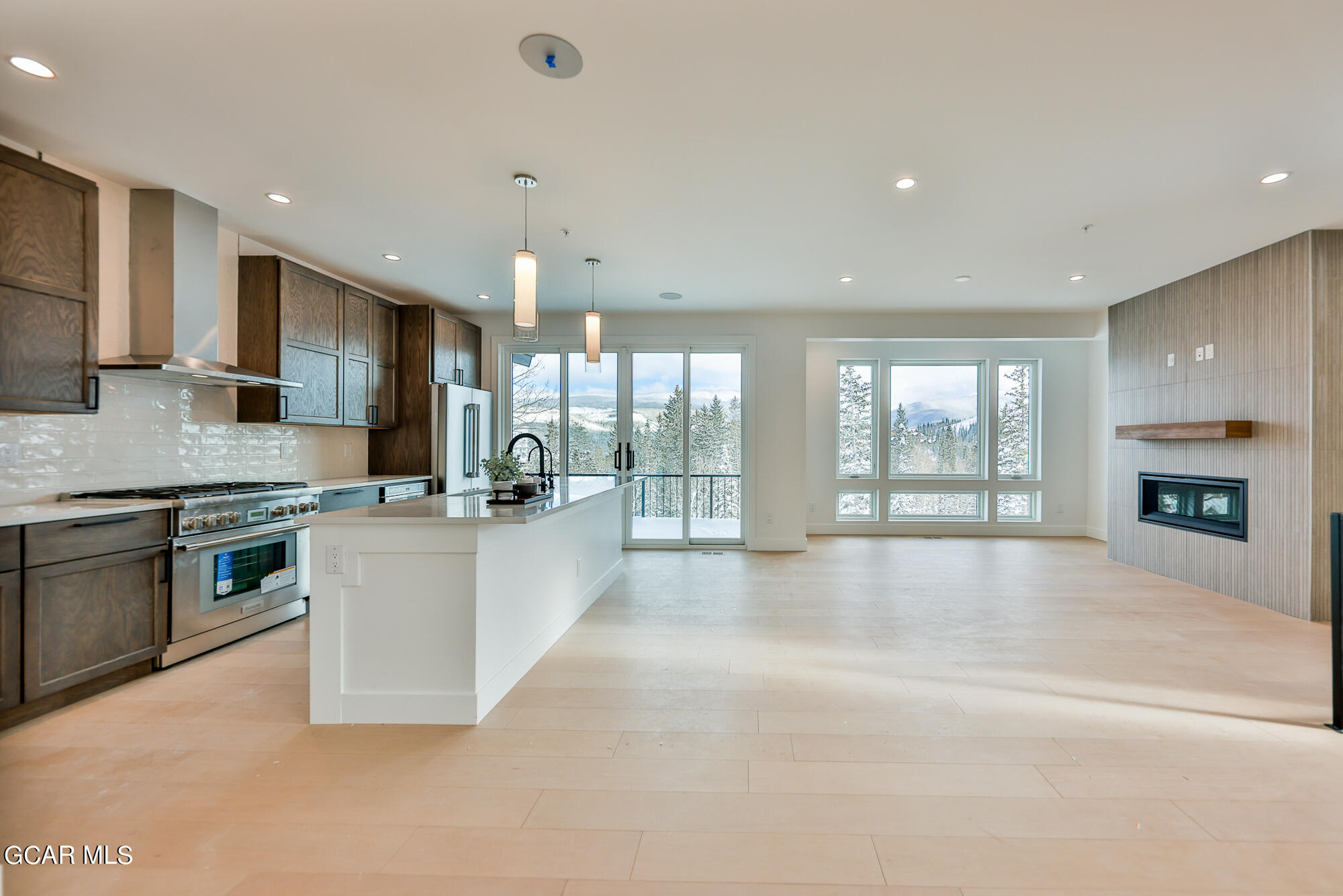 381 Bear Trail Winter Park, CO 80482 - Photo 4 of 38 a large kitchen with stainless steel appliances granite countertop a large counter top a stove and a sink