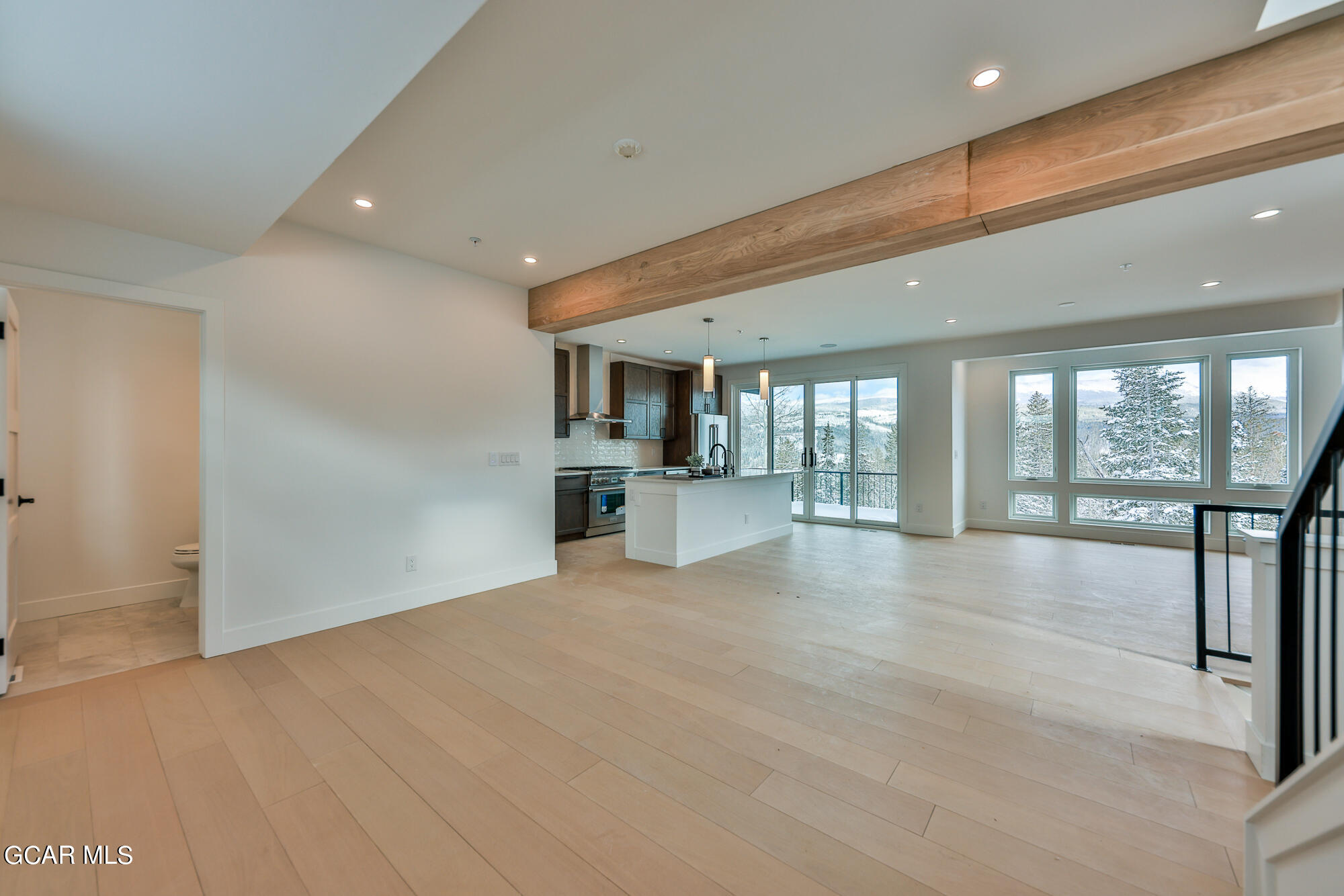 381 Bear Trail Winter Park, CO 80482 - Photo 9 of 38 a view of an empty room with a fireplace and large windows
