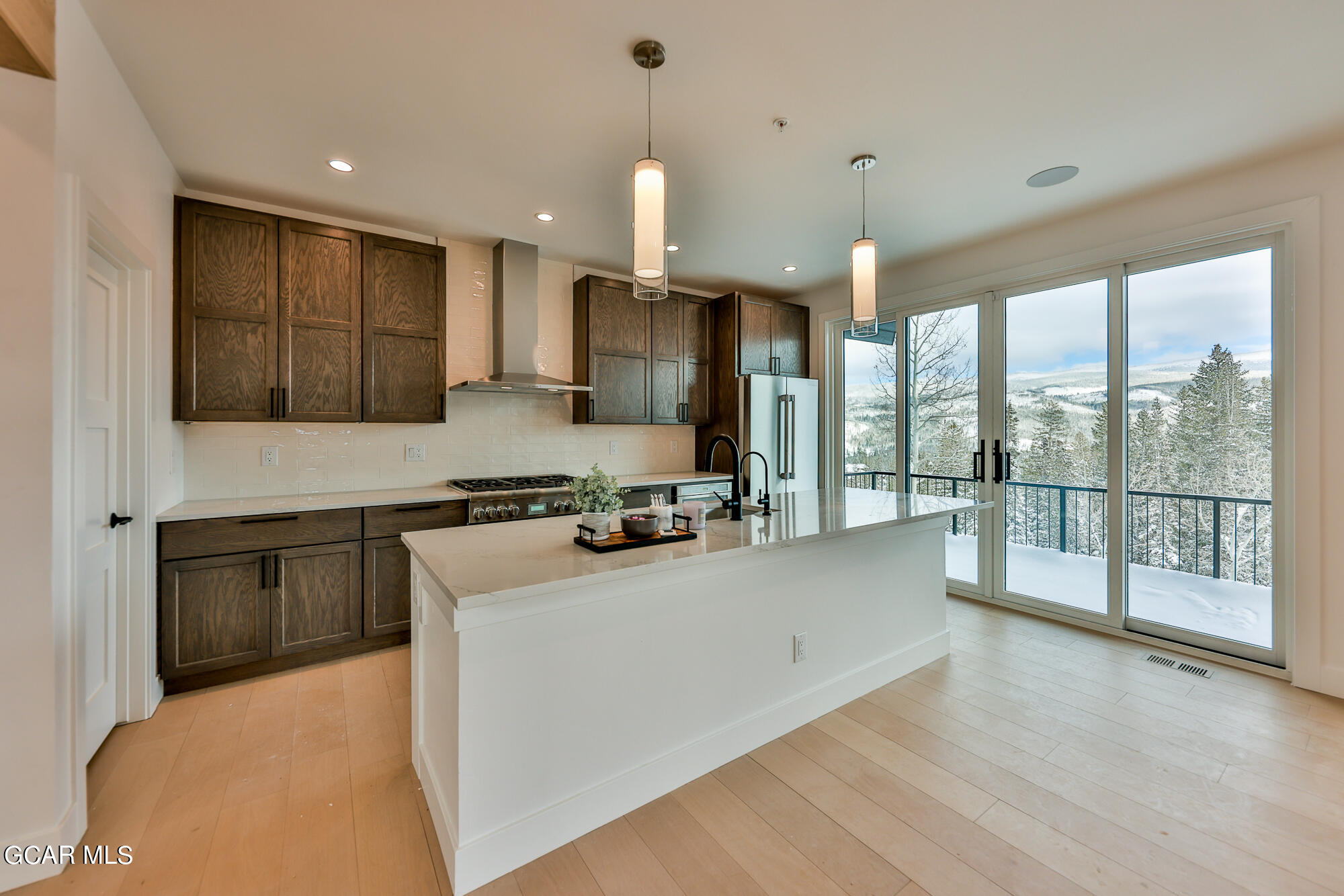 381 Bear Trail Winter Park, CO 80482 - Photo 10 of 38 a kitchen with stainless steel appliances granite countertop a sink a stove and a refrigerator