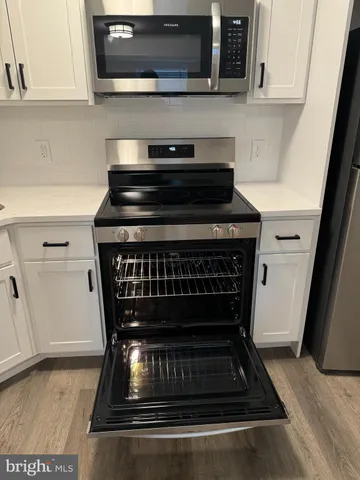 a stove top oven sitting inside of a kitchen