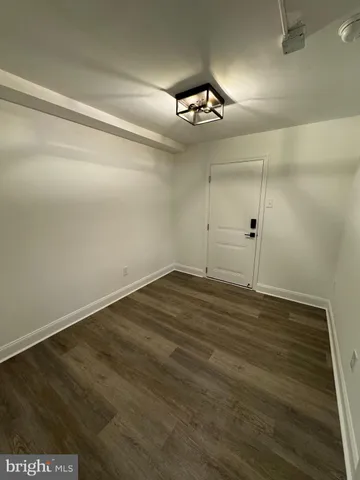 en empty room with wooden floor and ceiling fan