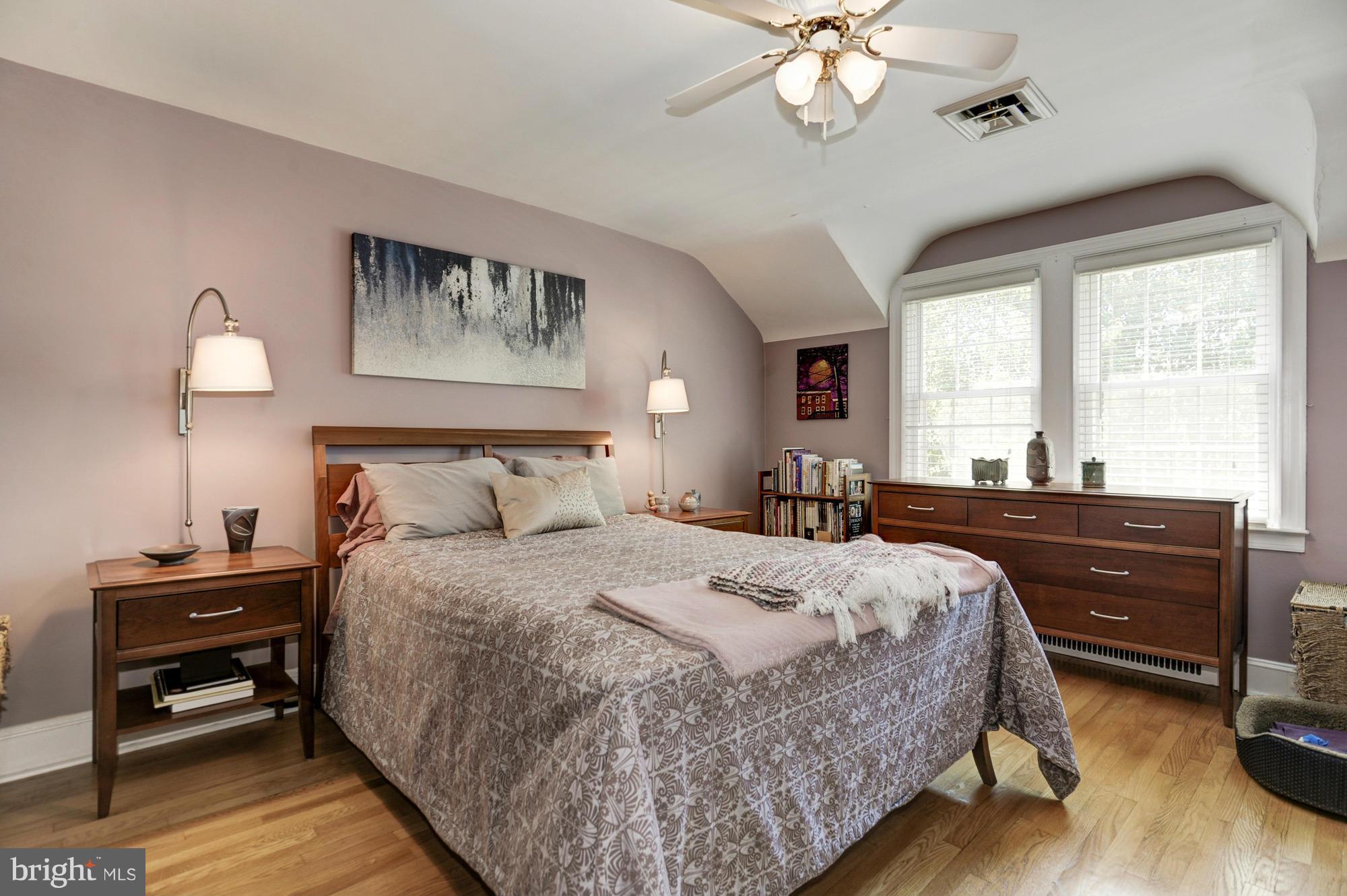 410 Hopkins Road Baltimore, MD 21212 - Photo 17 of 30 a bedroom with a bed and a chandelier