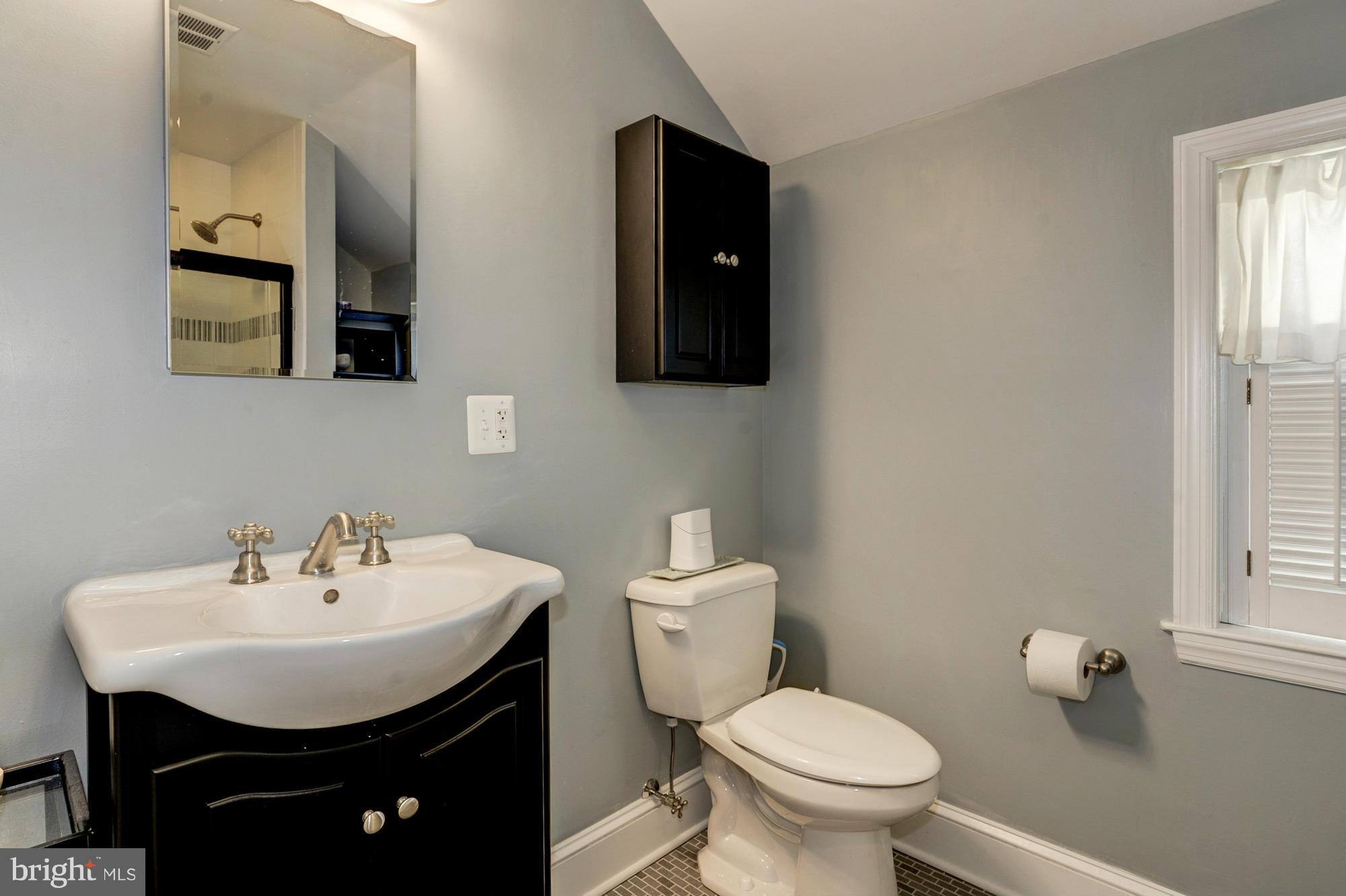 410 Hopkins Road Baltimore, MD 21212 - Photo 19 of 30 a bathroom with a toilet sink and mirror