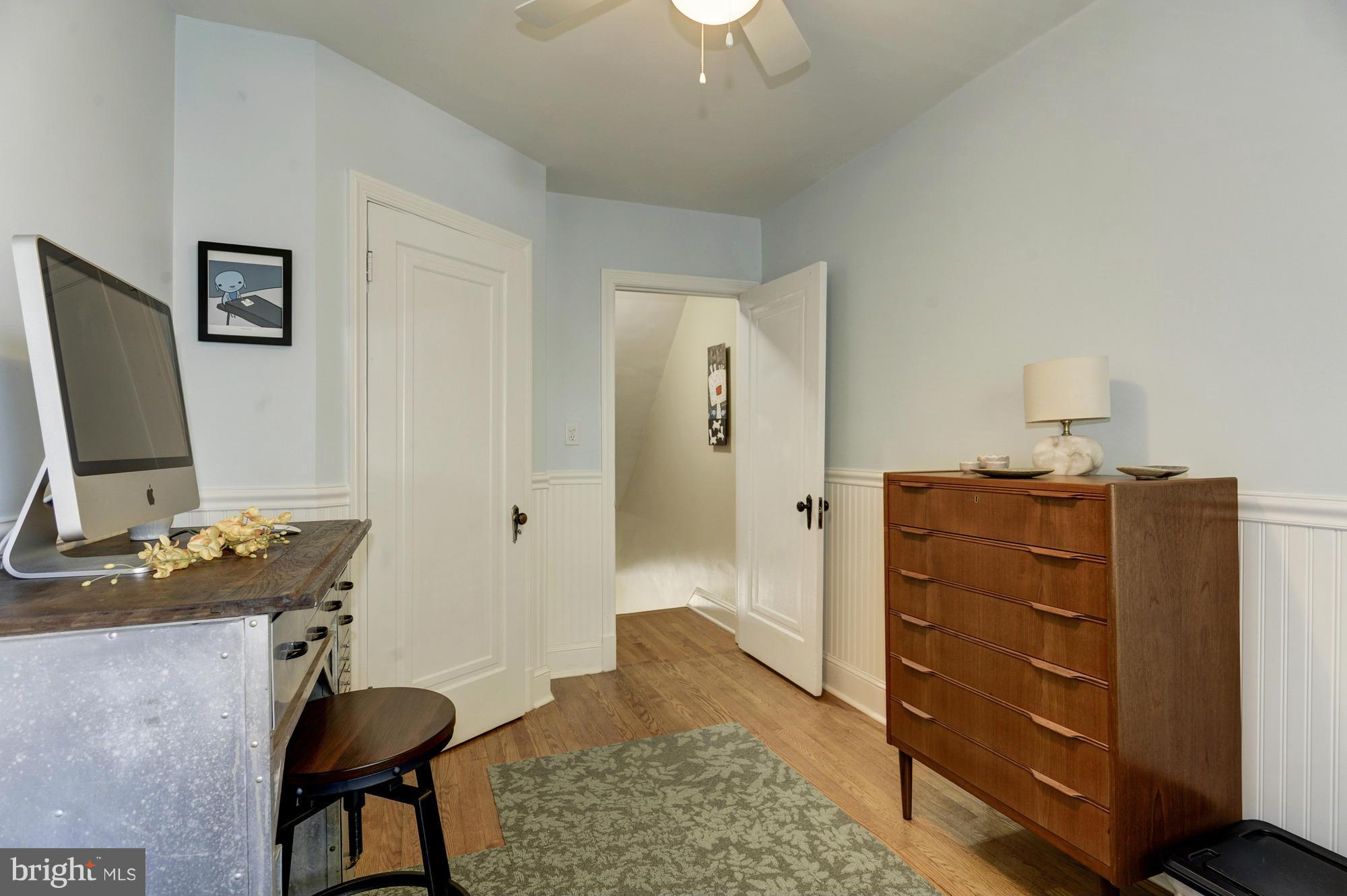 410 Hopkins Road Baltimore, MD 21212 - Photo 24 of 30 a bedroom with a bed and a chandelier