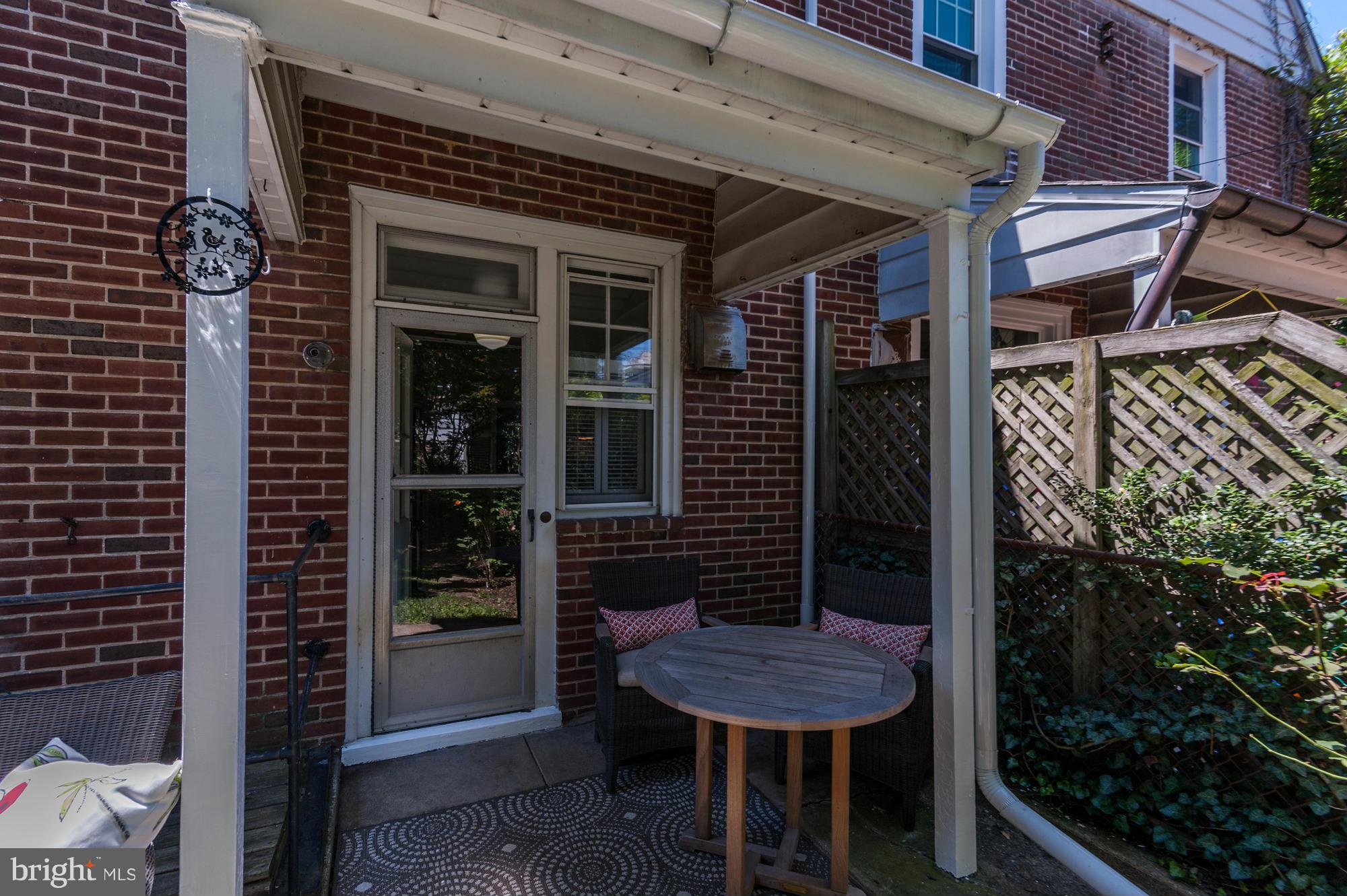 410 Hopkins Road Baltimore, MD 21212 - Photo 30 of 30 a backyard of a house with barbeque oven and outdoor seating