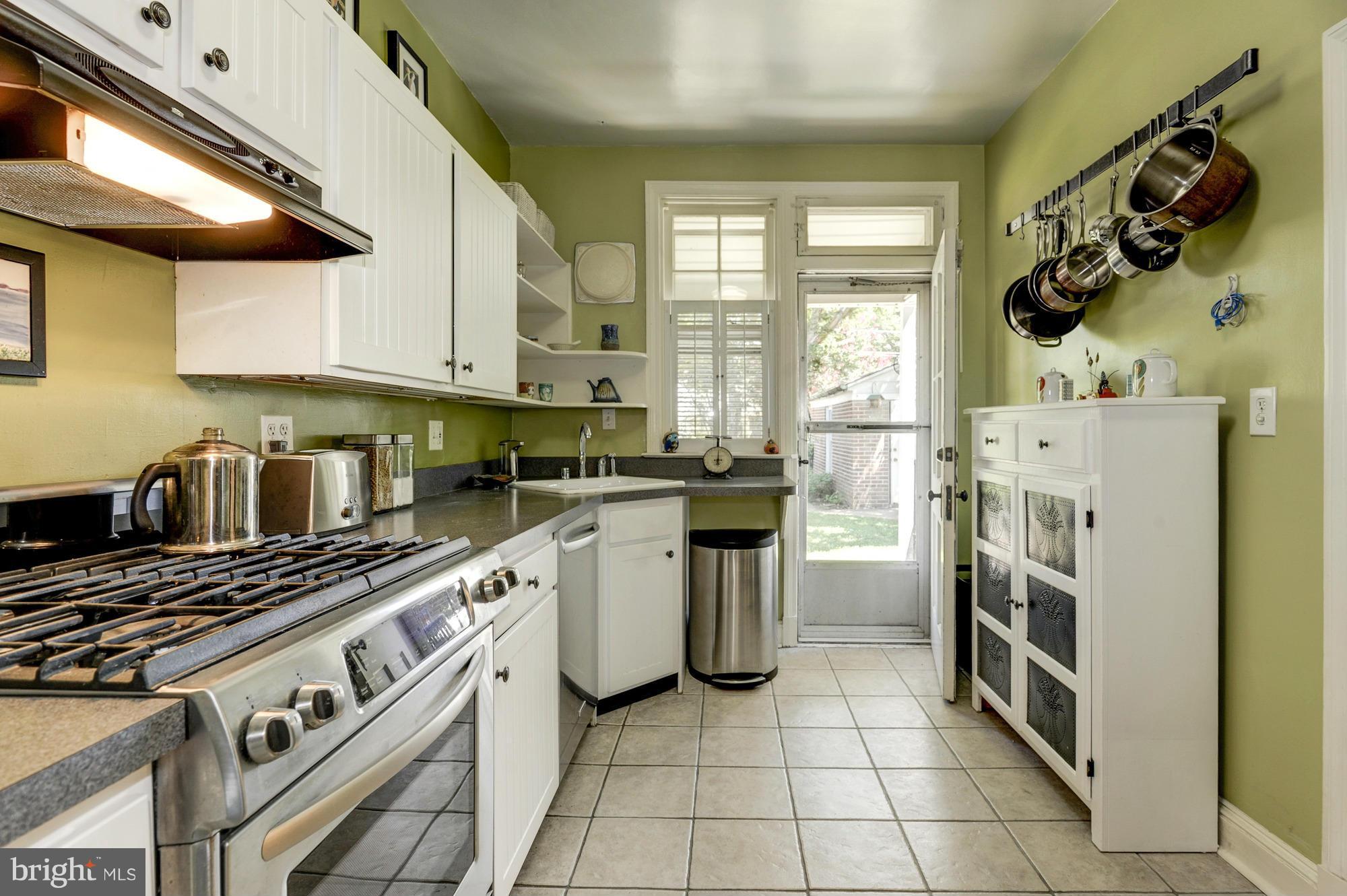 410 Hopkins Road Baltimore, MD 21212 - Photo 10 of 30 a kitchen with a stove a sink and a refrigerator