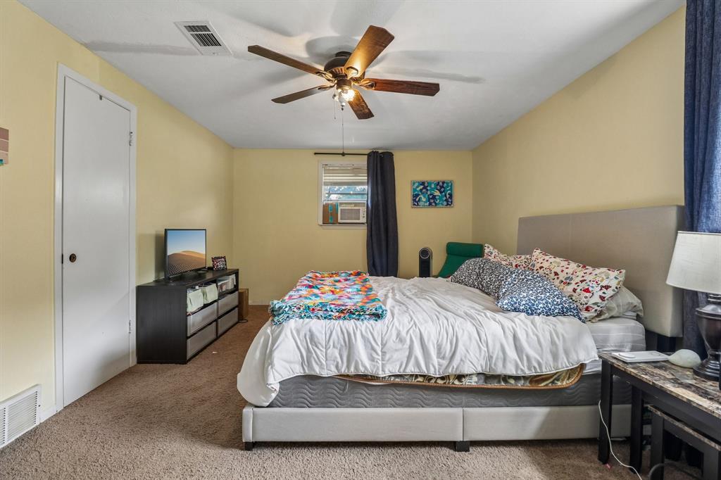 820 North Bowen Road Arlington, TX 76012 - Photo 20 of 40 a bedroom with a bed and a ceiling fan