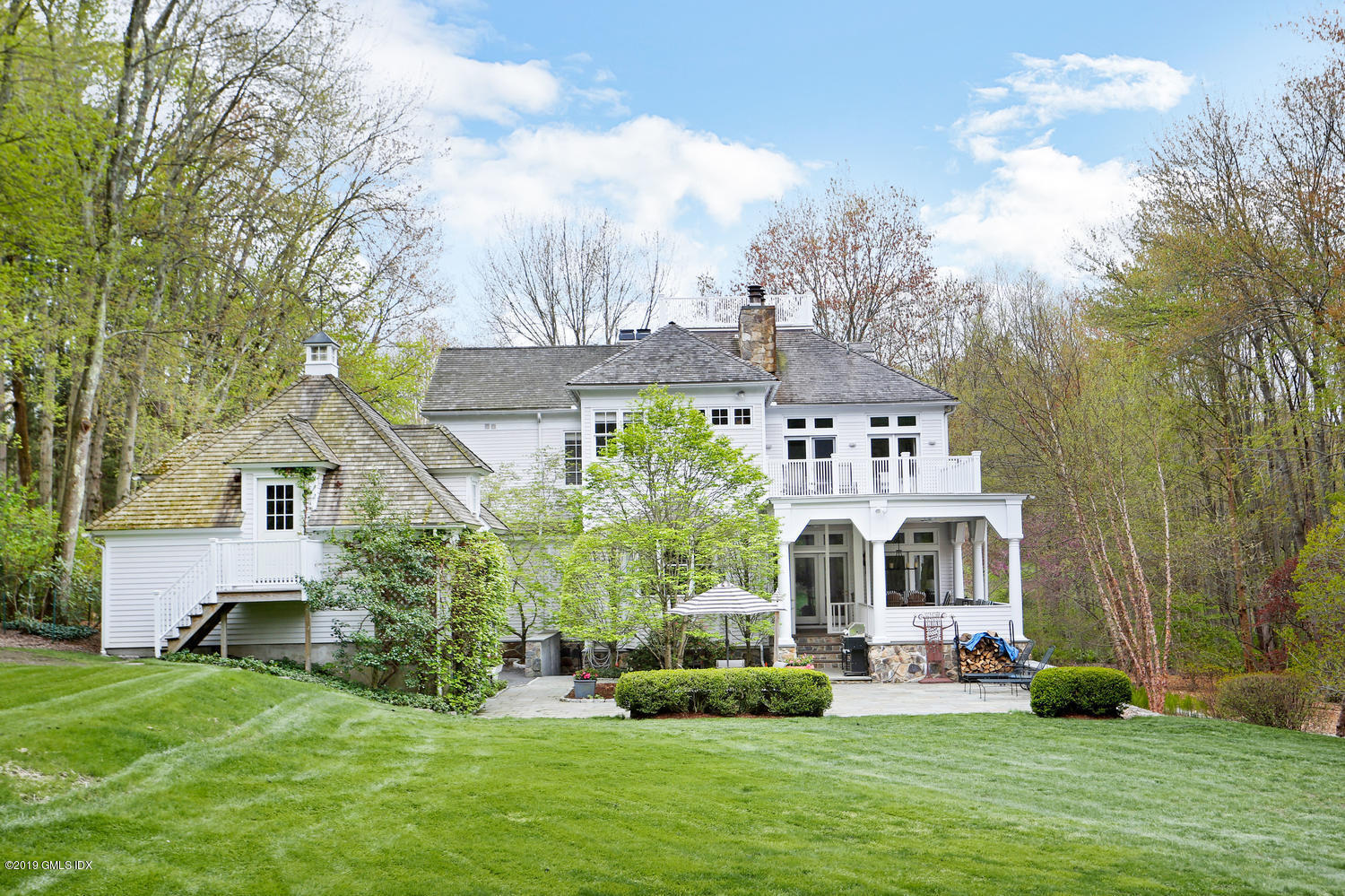 a front view of house with yard and green space