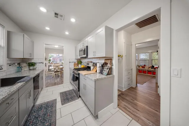 a kitchen with cabinets and a view of living room