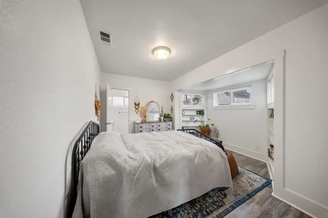 a bed room with a bed and a mirror