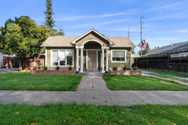 a front view of a house with a yard and outdoor seating