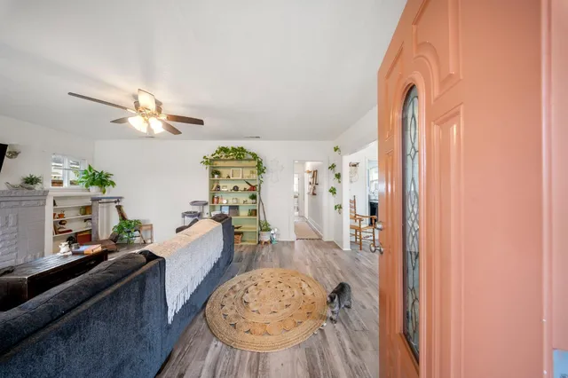 a living room with furniture and a chandelier