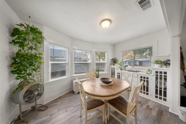 a view of a dining room with furniture and window