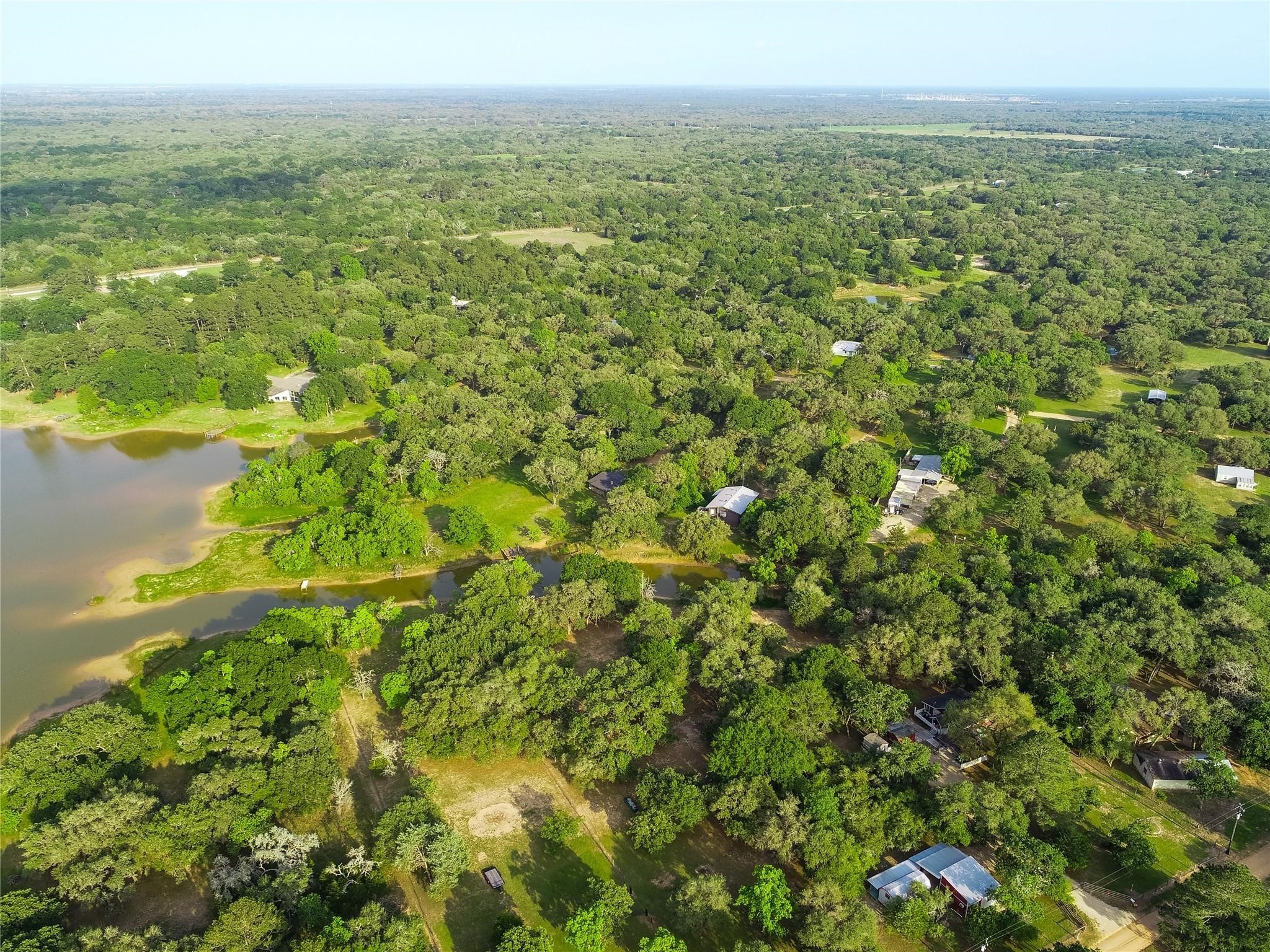 211 Bluebonnet Road Sheridan, TX 77475 - Photo 12 of 12 a view of a big yard with lots of bushes