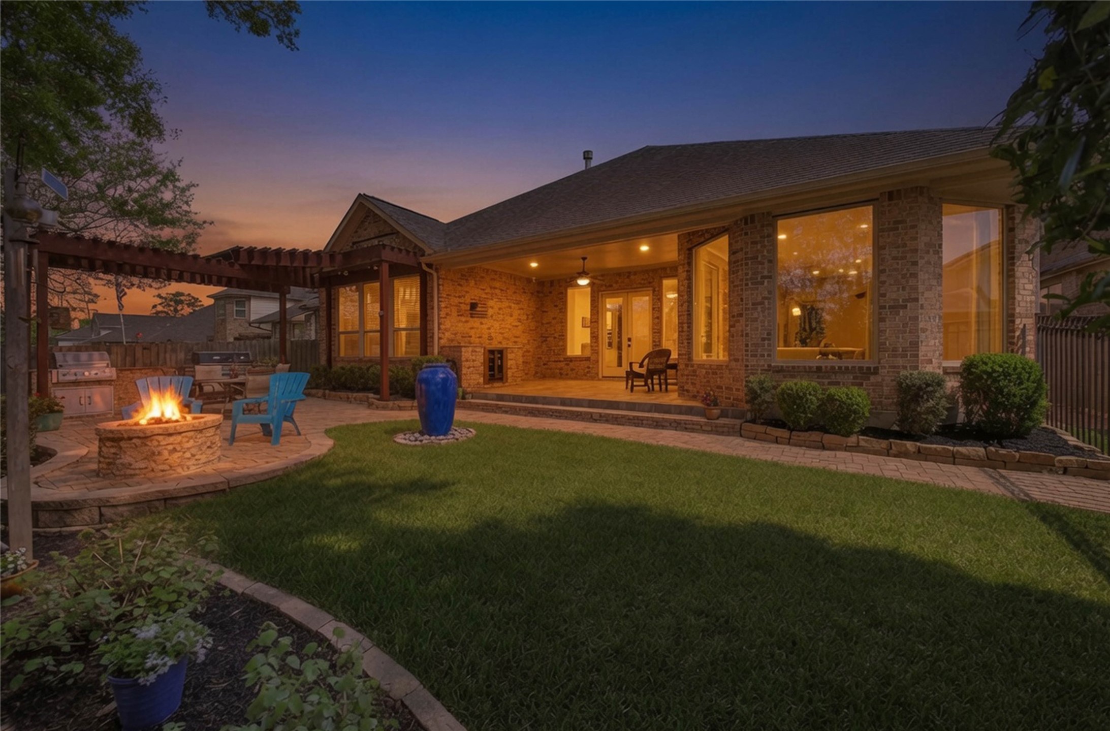 3234 Explorer Way Conroe, TX 77301 - Photo 2 of 46 A private courtyard retreat perfect for relaxing or entertaining, featuring inviting evening ambiance and seamless indoor-outdoor living.
