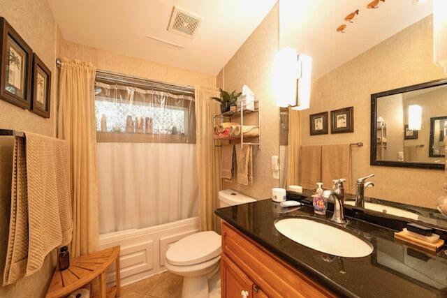 1218 Packer Street, Unit REAR Key West, FL 33040 - Photo 11 of 22 a bathroom with a granite countertop sink toilet a mirror and shower