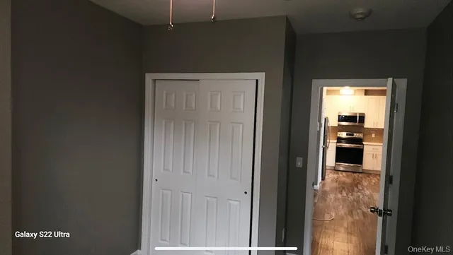 a view of a hallway with wooden floor