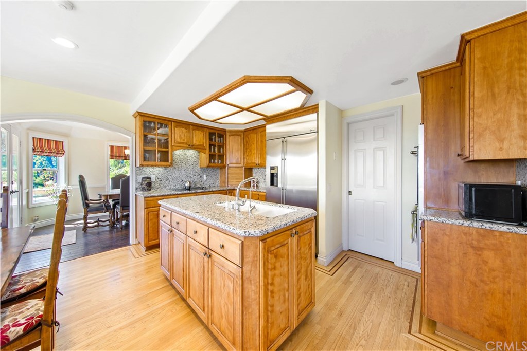 46250 Camaron Road Temecula, CA 92590 - Photo 20 of 46 a kitchen with a stove a refrigerator a dining table and chairs with wooden floor