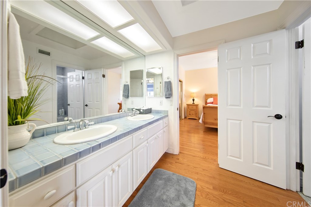 46250 Camaron Road Temecula, CA 92590 - Photo 29 of 46 a spacious bathroom with a granite countertop sink and a mirror