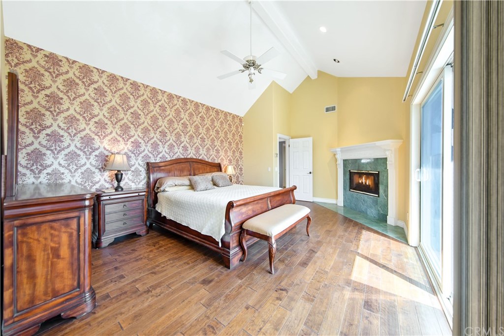 46250 Camaron Road Temecula, CA 92590 - Photo 32 of 46 a spacious bedroom with a bed and a dresser next to a window