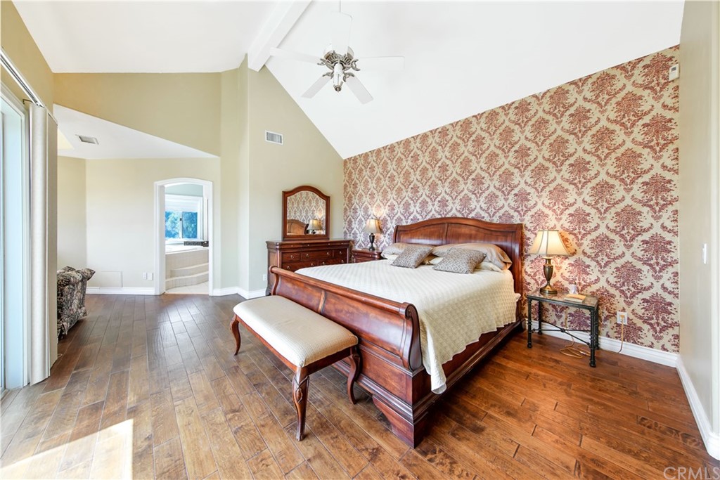 46250 Camaron Road Temecula, CA 92590 - Photo 33 of 46 a spacious bedroom with a bed and a chandelier