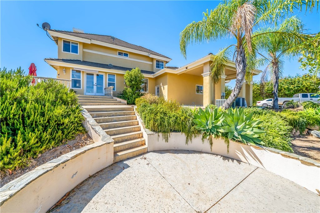 46250 Camaron Road Temecula, CA 92590 - Photo 41 of 46 a front view of a house with a yard and potted plants