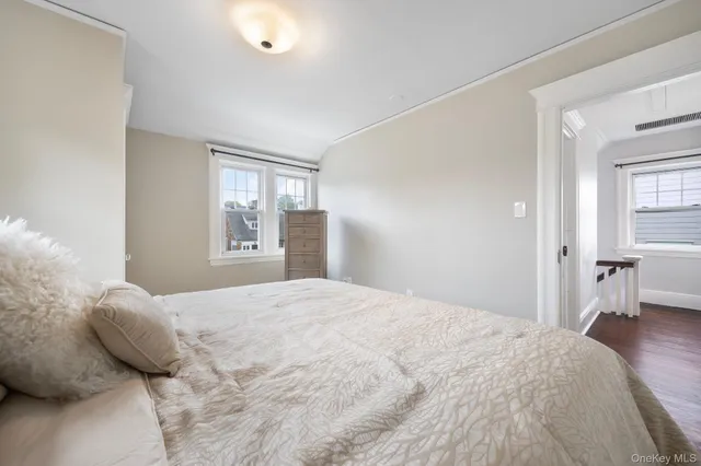 a bedroom with a large bed and a window