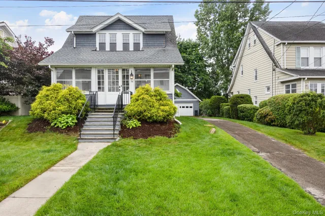 a front view of a house with a yard and porch