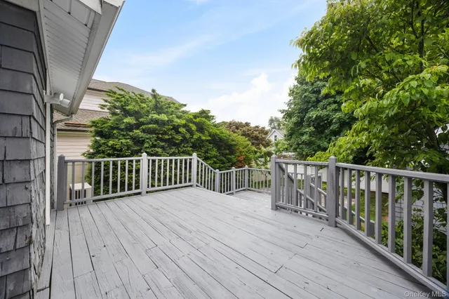 a balcony with wooden floor and fence