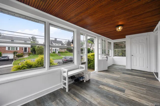 a view of a porch with furniture and floor to ceiling window