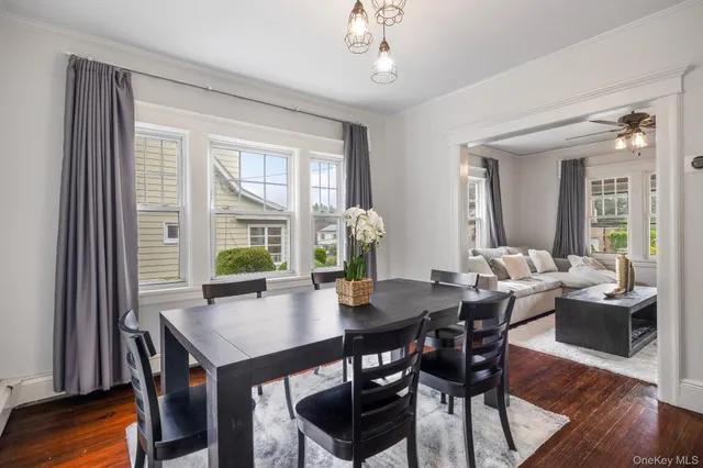 a view of a dining room with furniture window and wooden floor