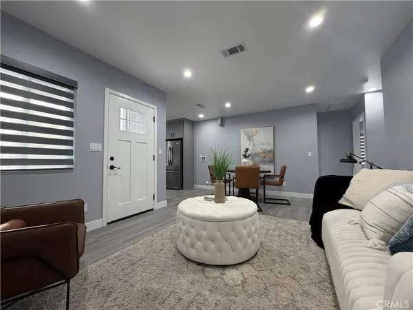 a living room with furniture and a potted plant