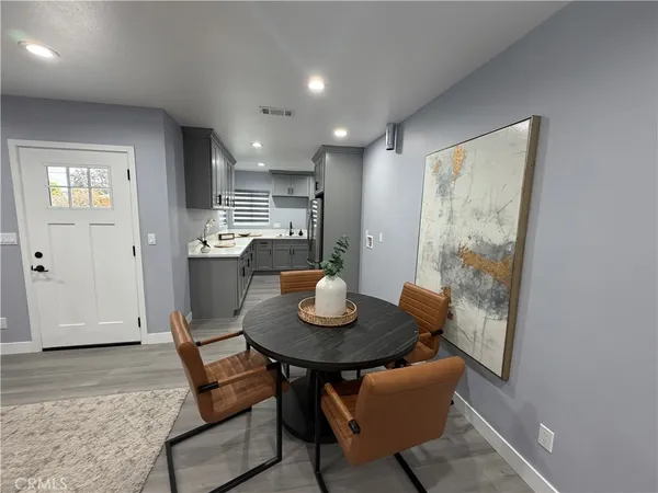 a view of a dining room with furniture and wooden floor